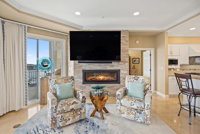 living room featuring light tile patterned floors, a large fireplace, and crown molding