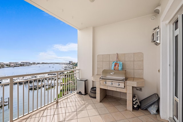 balcony featuring a water view and grilling area