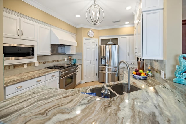 kitchen featuring pendant lighting, white cabinetry, appliances with stainless steel finishes, and custom range hood