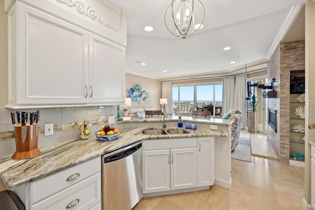 kitchen with white cabinetry, stainless steel dishwasher, and kitchen peninsula