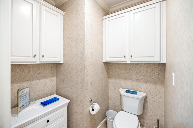 bathroom with toilet and ornamental molding