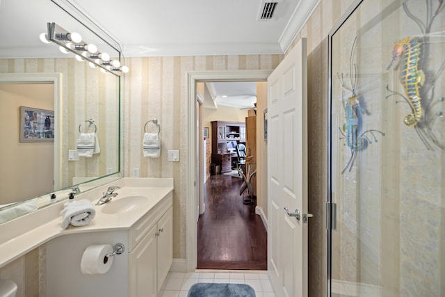 bathroom with vanity, tile patterned flooring, crown molding, and walk in shower