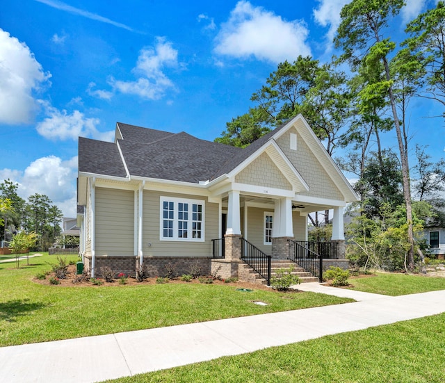 craftsman-style house with a front lawn and covered porch