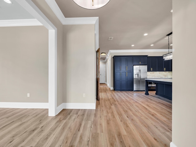 interior space with decorative backsplash, ornamental molding, light countertops, light wood-style floors, and stainless steel refrigerator with ice dispenser