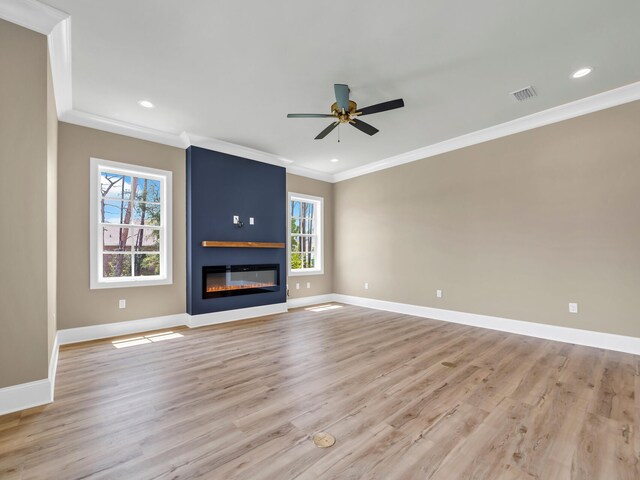 unfurnished living room with ceiling fan, light hardwood / wood-style flooring, a fireplace, and ornamental molding