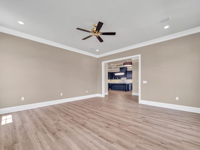 unfurnished living room with light wood-style floors, baseboards, ornamental molding, and ceiling fan