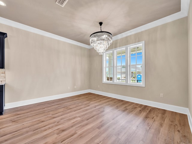 interior space featuring crown molding, light wood-type flooring, and an inviting chandelier