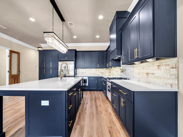 kitchen featuring appliances with stainless steel finishes, crown molding, blue cabinets, backsplash, and light wood-type flooring