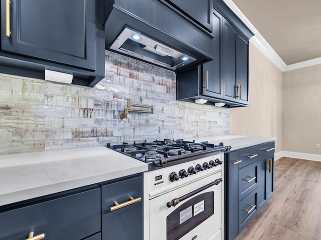 kitchen with custom range hood, light hardwood / wood-style floors, high end range, ornamental molding, and tasteful backsplash