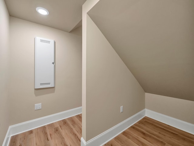 bonus room featuring light hardwood / wood-style flooring and vaulted ceiling