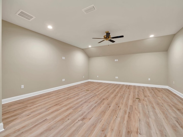 spare room featuring lofted ceiling, visible vents, ceiling fan, and baseboards