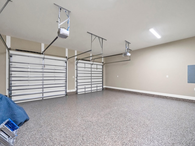 garage featuring baseboards, electric panel, and a garage door opener