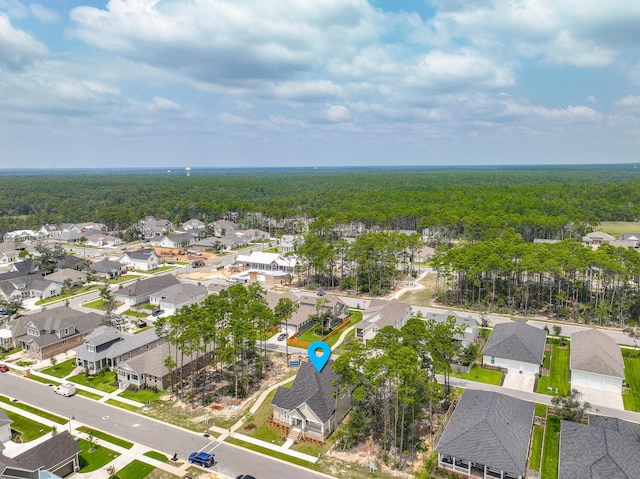 bird's eye view featuring a residential view and a forest view