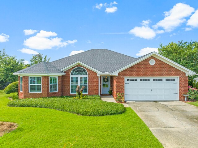 ranch-style home with a garage and a front lawn