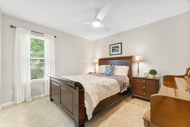 bedroom with light carpet and ceiling fan