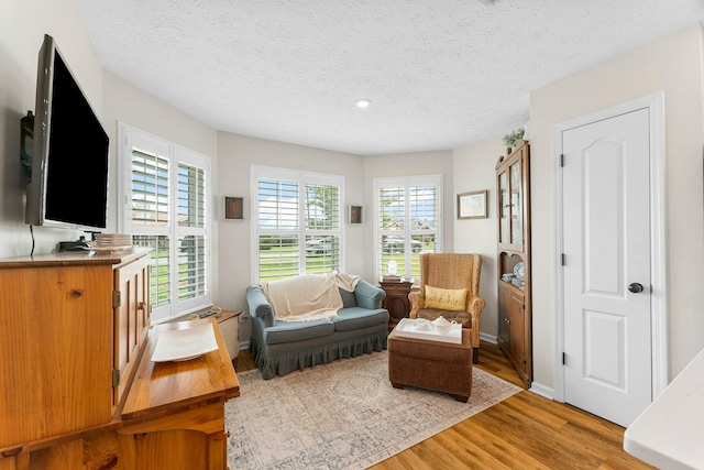 sitting room featuring a textured ceiling and hardwood / wood-style flooring