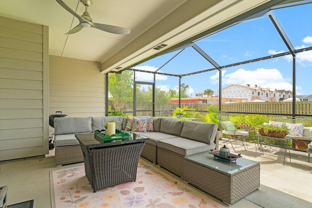 sunroom / solarium featuring a healthy amount of sunlight and ceiling fan