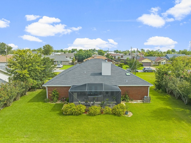 rear view of property with a lawn