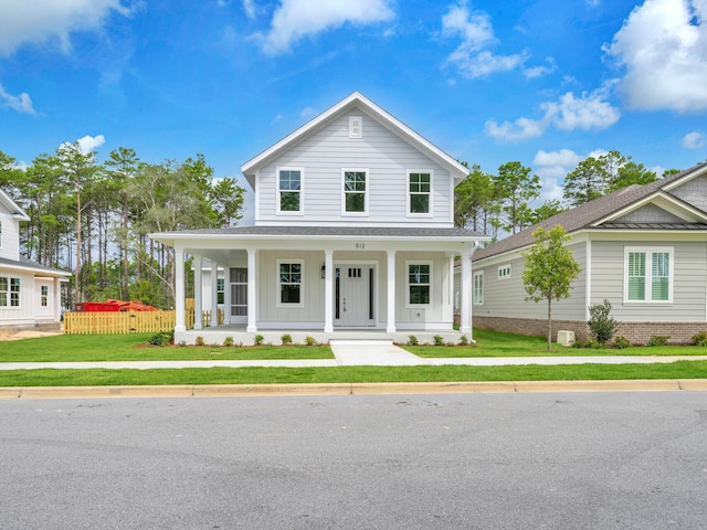 view of front facade with a front lawn and covered porch