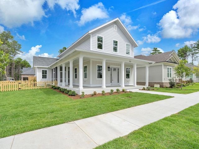 country-style home featuring covered porch and a front yard