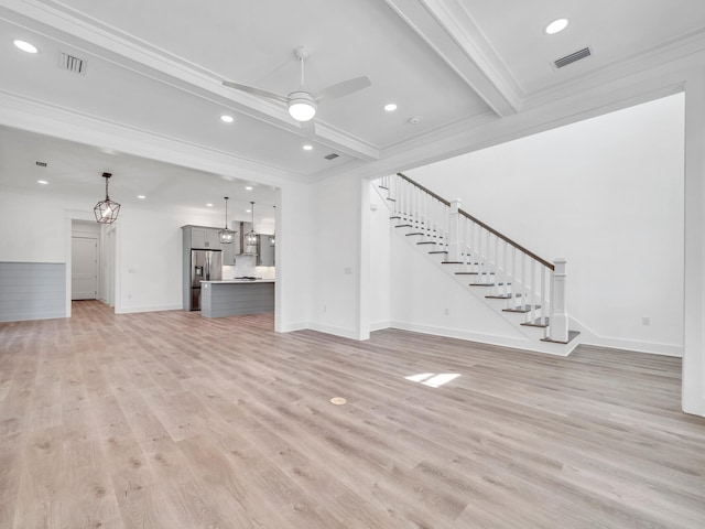 unfurnished living room with beamed ceiling, ornamental molding, light wood-type flooring, and ceiling fan