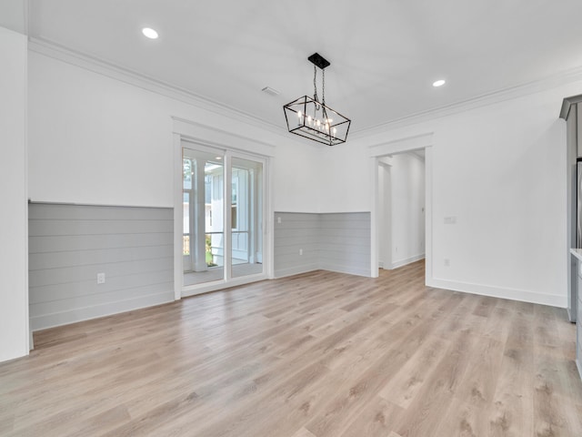 interior space with ornamental molding, light hardwood / wood-style flooring, and a notable chandelier