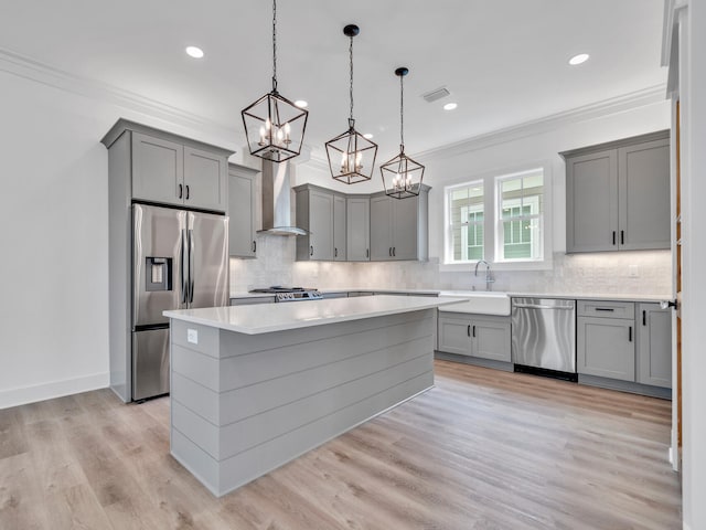 kitchen with decorative backsplash, stainless steel appliances, and light hardwood / wood-style flooring