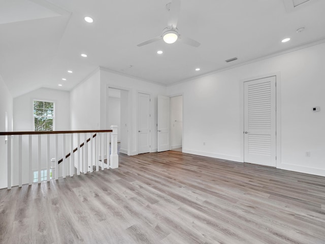 interior space with light hardwood / wood-style floors, vaulted ceiling, crown molding, and ceiling fan