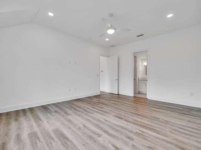 empty room featuring light hardwood / wood-style flooring, lofted ceiling, and ceiling fan