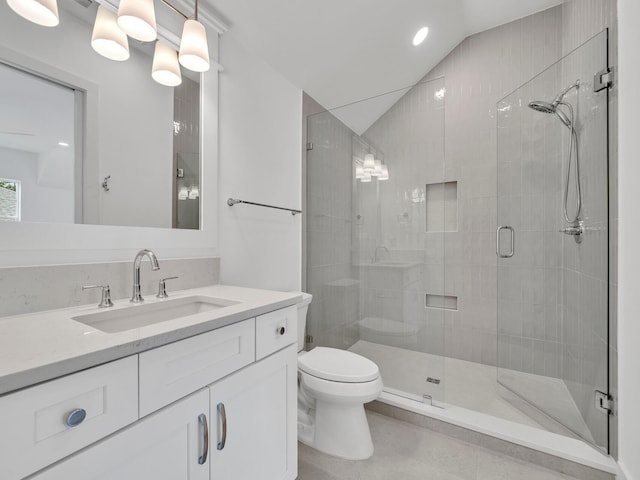 bathroom featuring a shower with shower door, vaulted ceiling, tile patterned flooring, toilet, and vanity