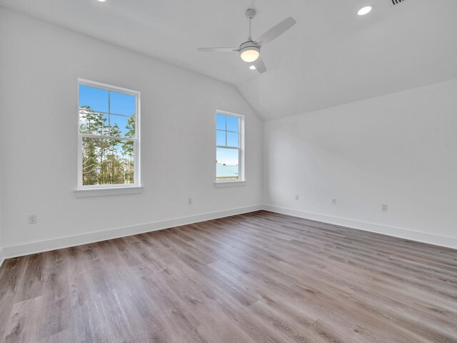 unfurnished room with ceiling fan, wood-type flooring, and vaulted ceiling