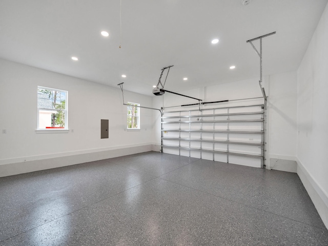 garage with electric panel and a garage door opener