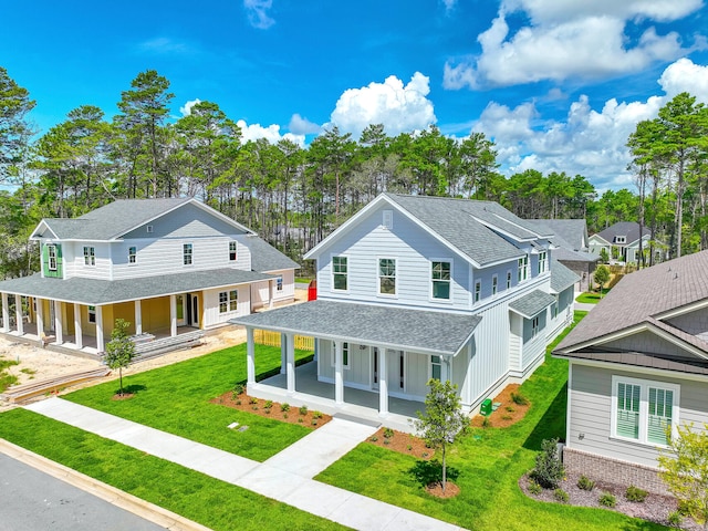 country-style home with a porch and a front yard