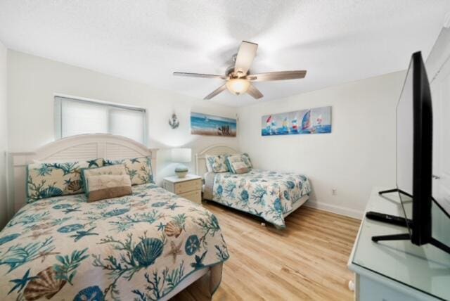 bedroom with light hardwood / wood-style flooring and ceiling fan