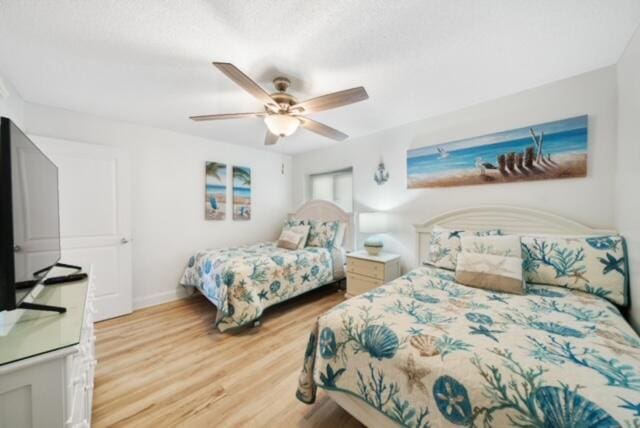 bedroom with light hardwood / wood-style floors and ceiling fan