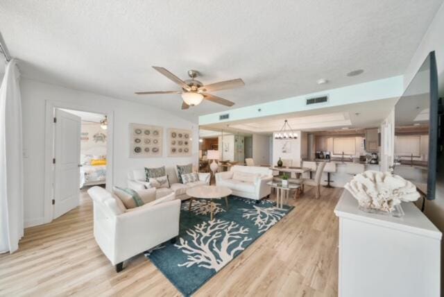 living room featuring light hardwood / wood-style floors and ceiling fan