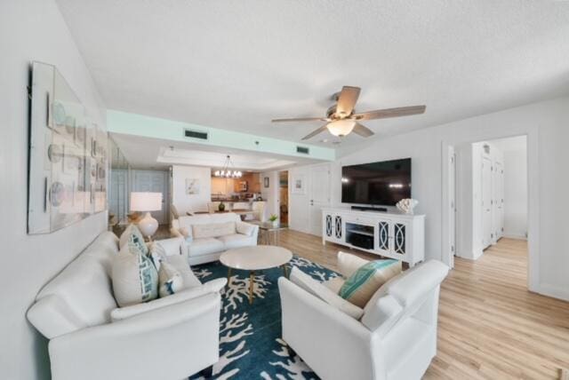 living room with light hardwood / wood-style flooring and ceiling fan