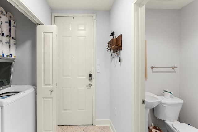 clothes washing area featuring washer / clothes dryer and light tile patterned floors