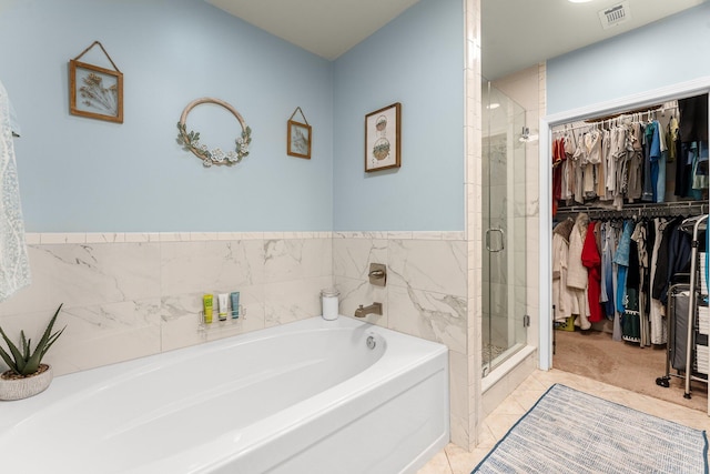 bathroom featuring tile patterned floors and independent shower and bath