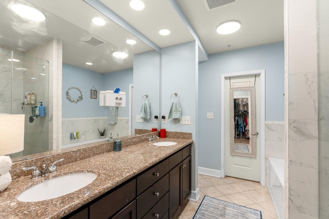 bathroom featuring tile patterned flooring, vanity, and independent shower and bath