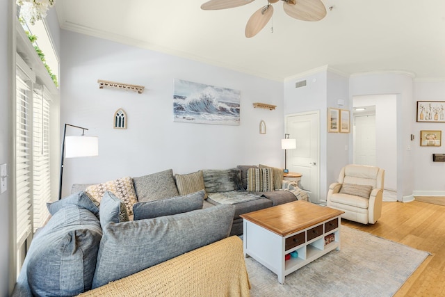 living room featuring ceiling fan, light wood-type flooring, and ornamental molding