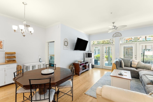 living room with french doors, light hardwood / wood-style floors, ceiling fan with notable chandelier, and ornamental molding