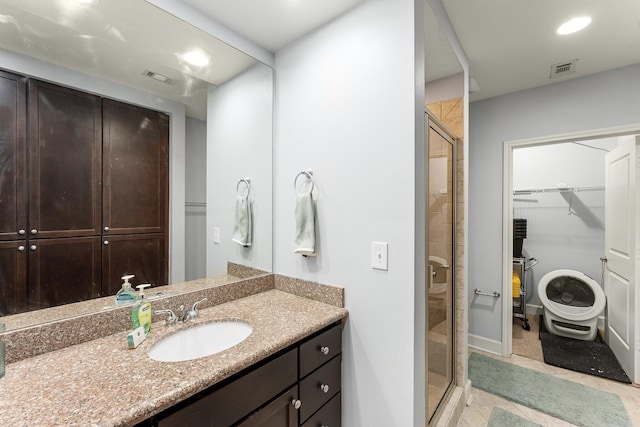 bathroom featuring vanity and an enclosed shower