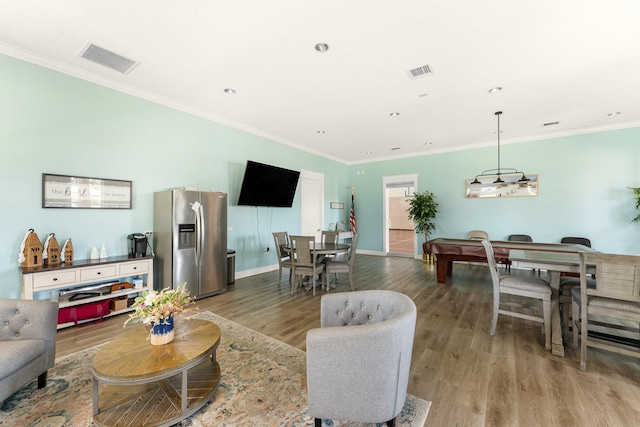 living room with crown molding, billiards, and light wood-type flooring