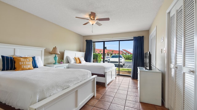 bedroom featuring light tile patterned flooring, a textured ceiling, and ceiling fan