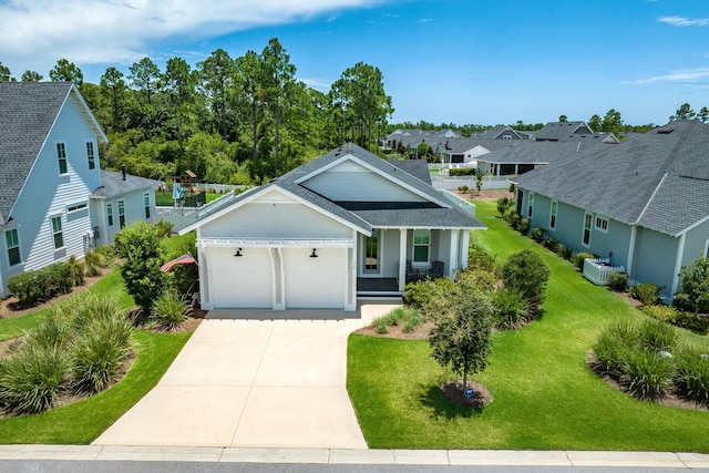 view of front of property featuring a porch, a garage, and a front lawn