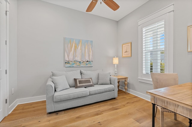 living room with hardwood / wood-style floors, plenty of natural light, and ceiling fan