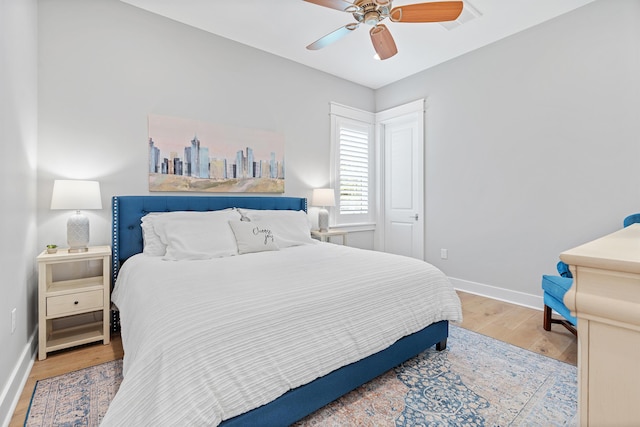 bedroom with wood-type flooring and ceiling fan