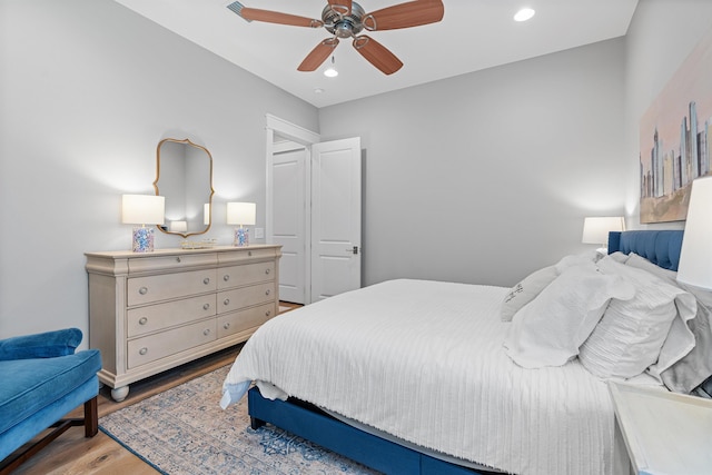 bedroom with ceiling fan and light hardwood / wood-style flooring