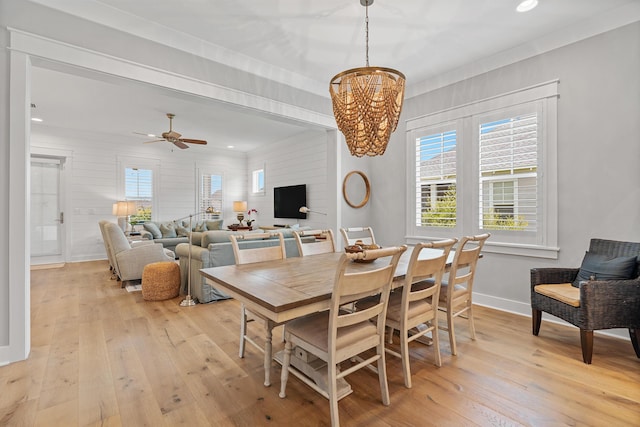 dining room featuring ceiling fan with notable chandelier and light wood-type flooring